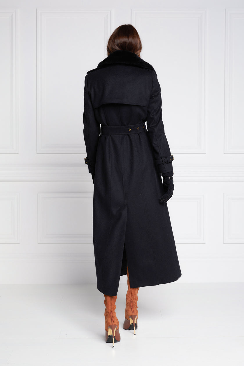 back of womens black wool double breasted full length trench coat with black faux fur collar