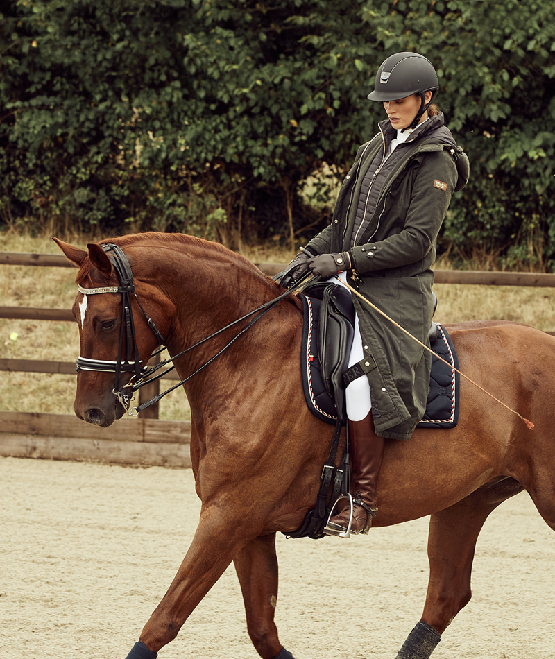 Horse rider with khaki longline training coat