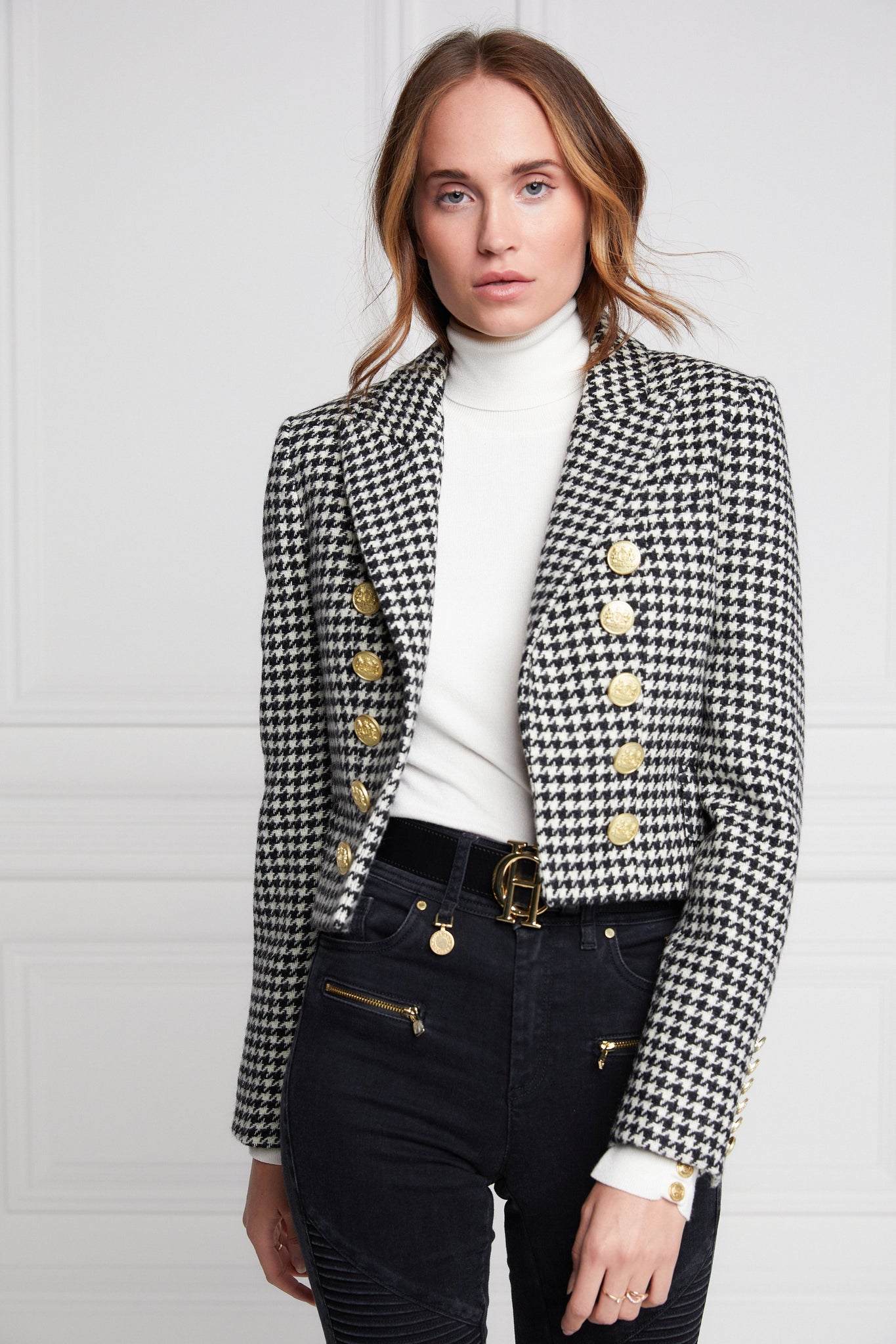 British made tailored cropped jacket in black and white houndstooth with welt pockets and gold button detail down the front and on sleeves