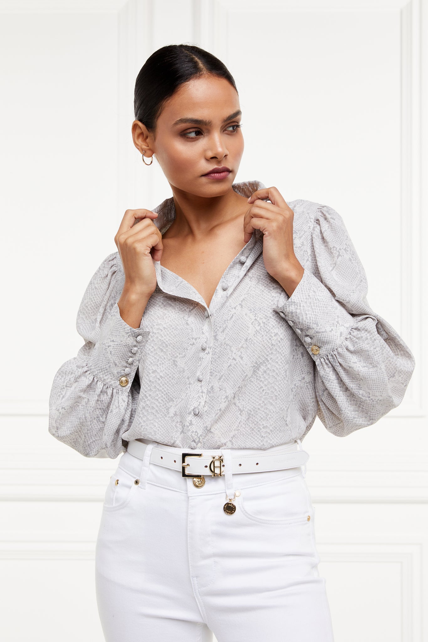 A classic fitted shirt with long sleeves and subtle puffy shoulders with grey snake print design with extra long cuffs and rounded collar detailed with fabric buttons 