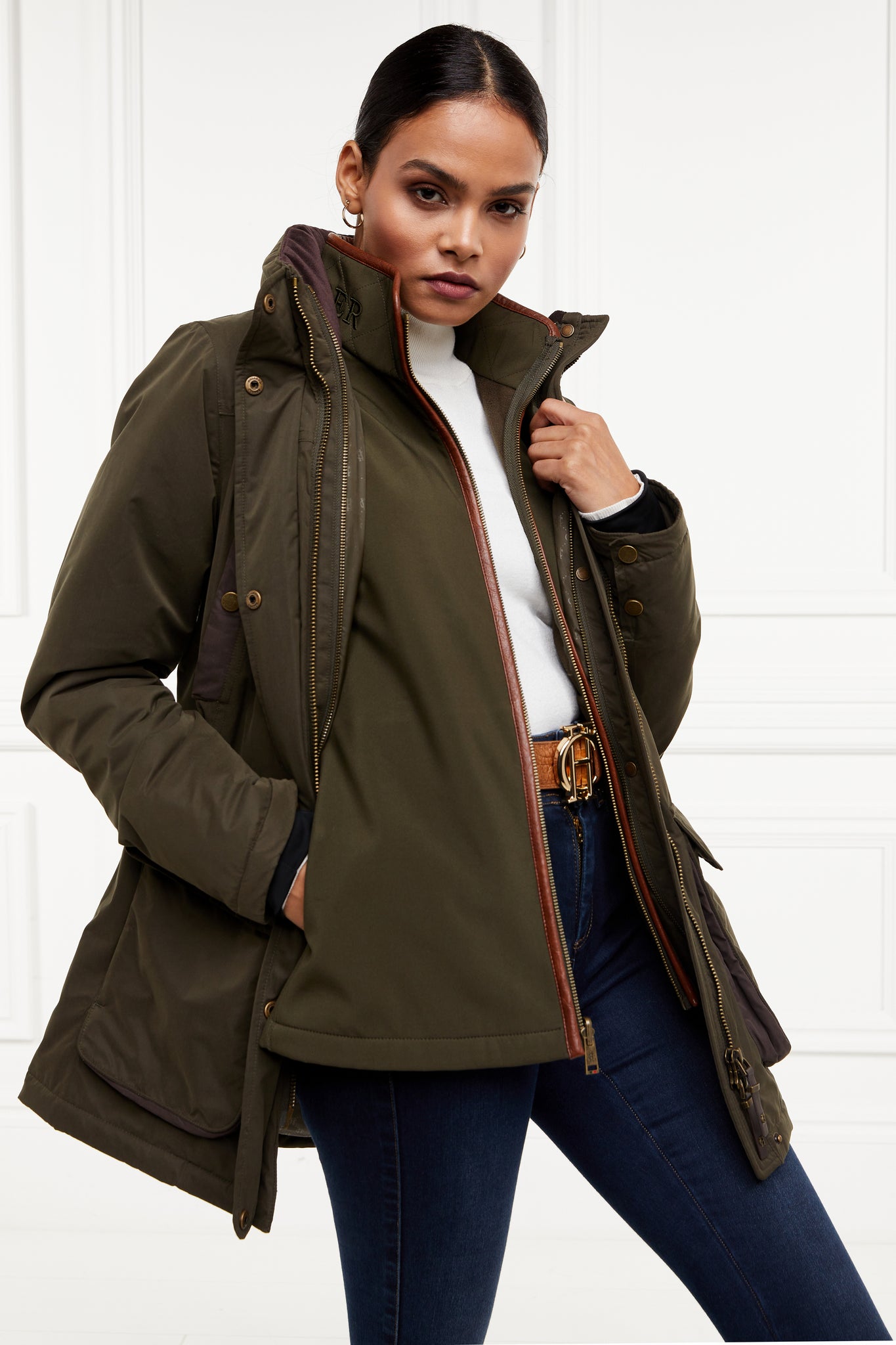 multiway coat in khaki that works as a 3 in 1 a waterproof outer coat with stowaway hood and deep pockets and black jersey storm cuffs and a fleece gilet inner with tan leather trims can be worn together or separately