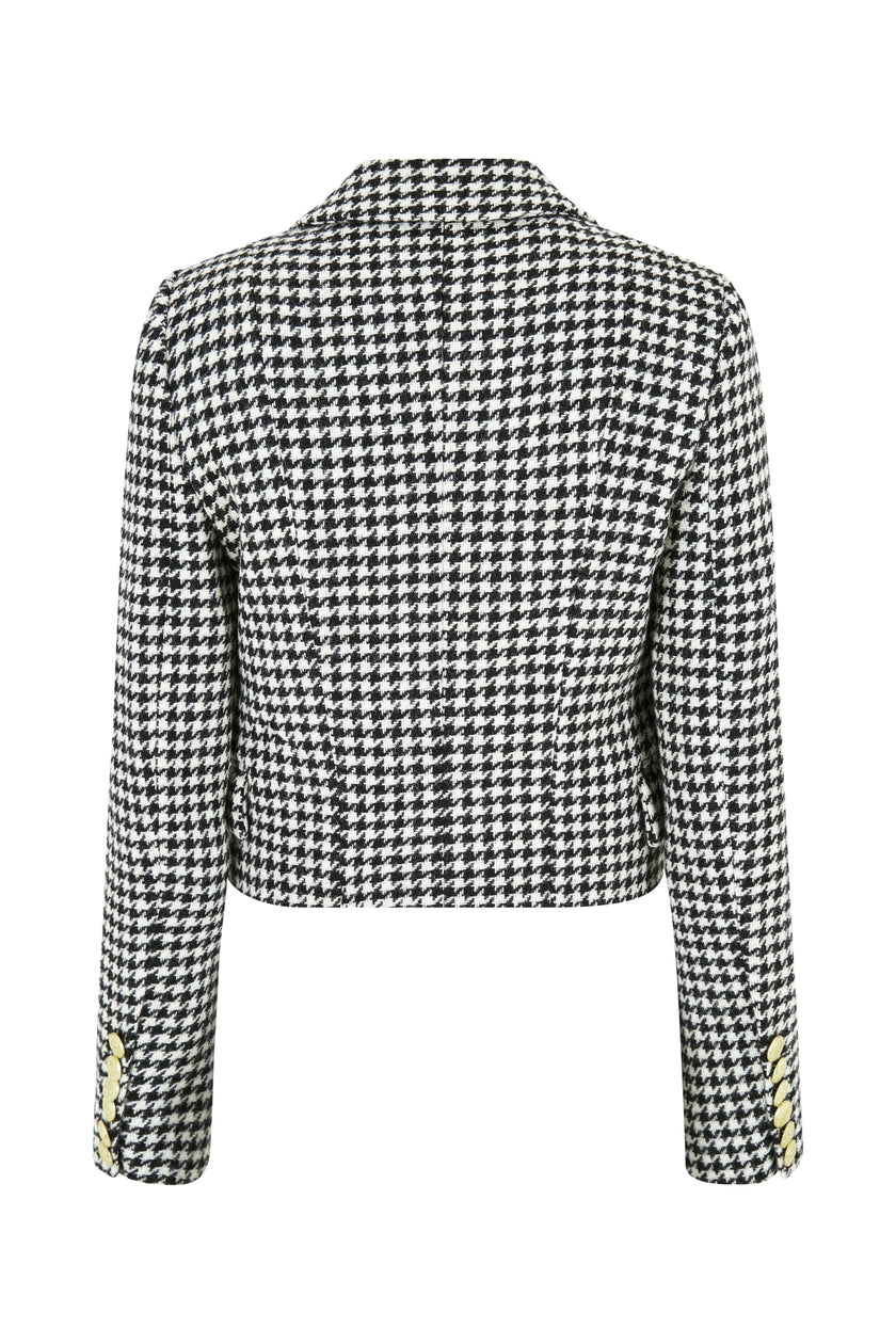 back of British made tailored cropped jacket in black and white houndstooth with welt pockets and gold button detail down the front and on sleeves