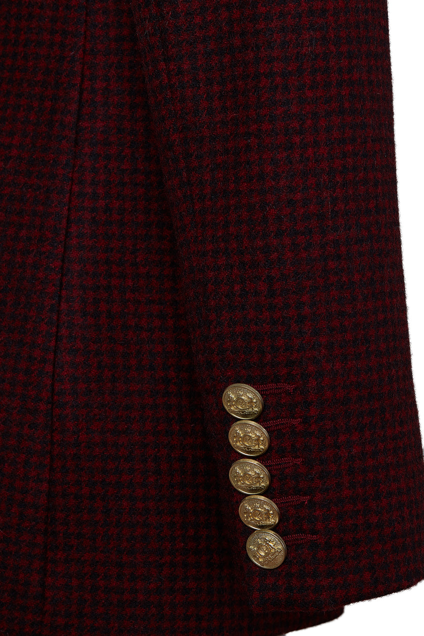 gold button detail on cuffs of double breasted wool blazer in deep red houndstooth with two hip pockets and gold button detials down front and on cuffs and handmade in the uk