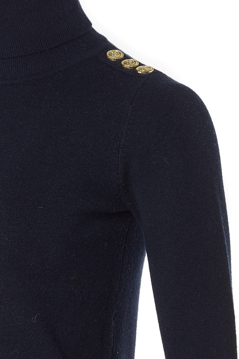 gold button detail across shoulders of super soft lightweight jumper in navy with ribbed roll neck collar, cuffs and hem