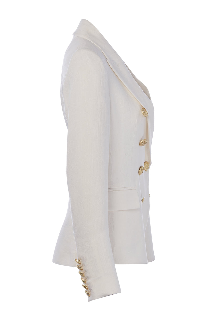 side of British made double breasted blazer that fastens with a single button hole to create a more form fitting silhouette with two pockets and gold button detailing this blazer in white linen