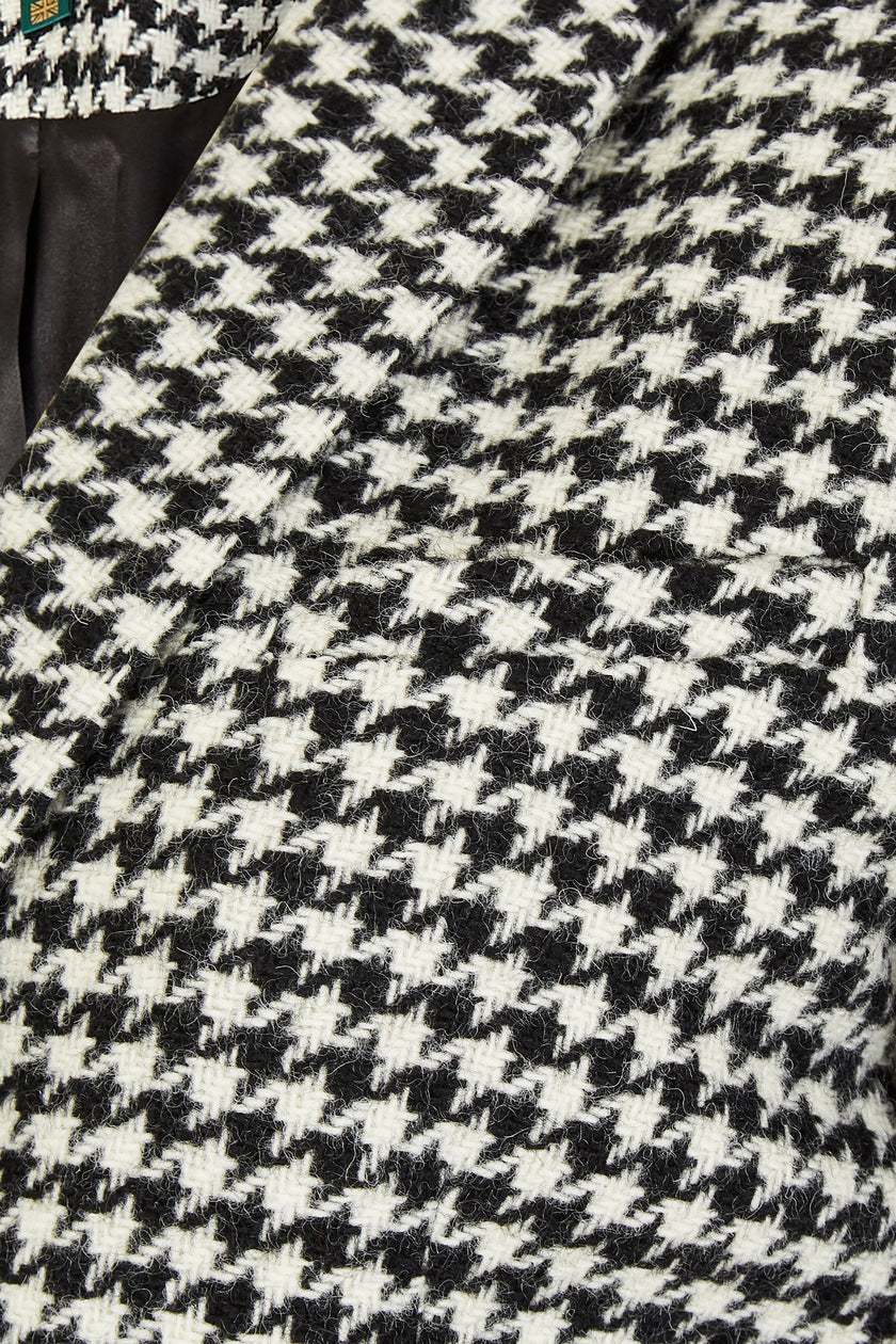 pocket detail of white and black houndstooth tweed womens coat with gold hardware and black leather detailing