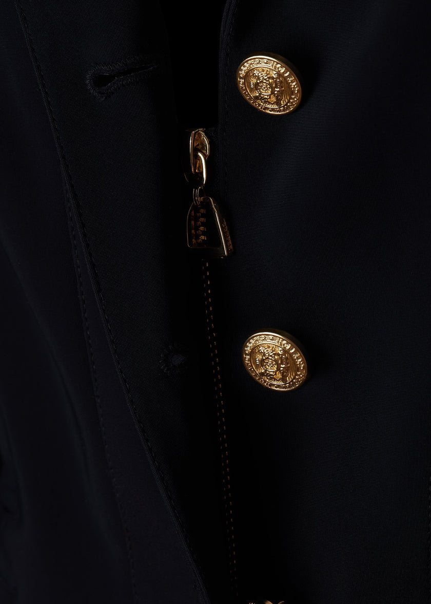 zip detail of womens navy competition jacket with gold hardware 