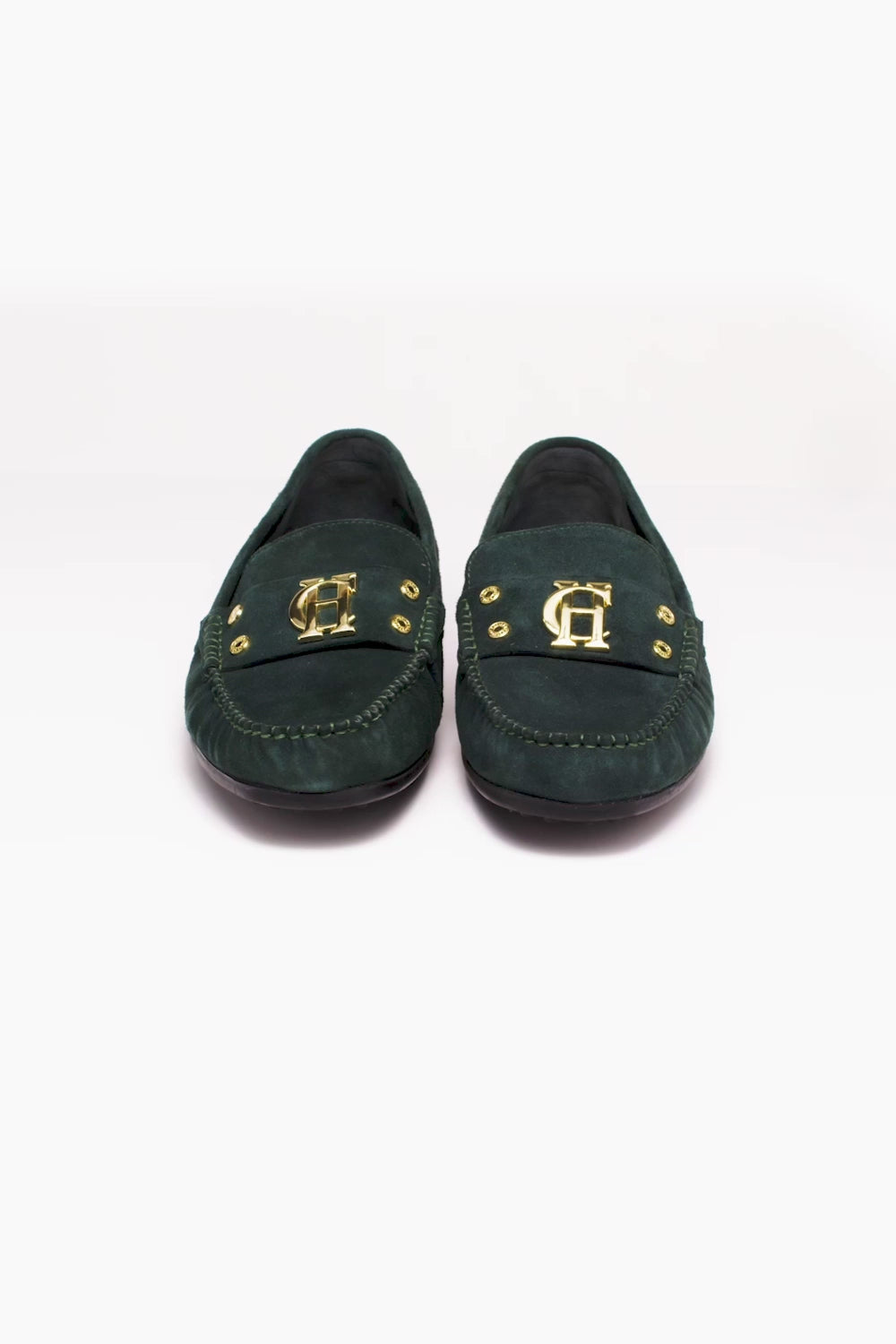 360 video of classic emerald green suede loafers with a leather sole and top stitching details and gold hardware with a dark green inner sole